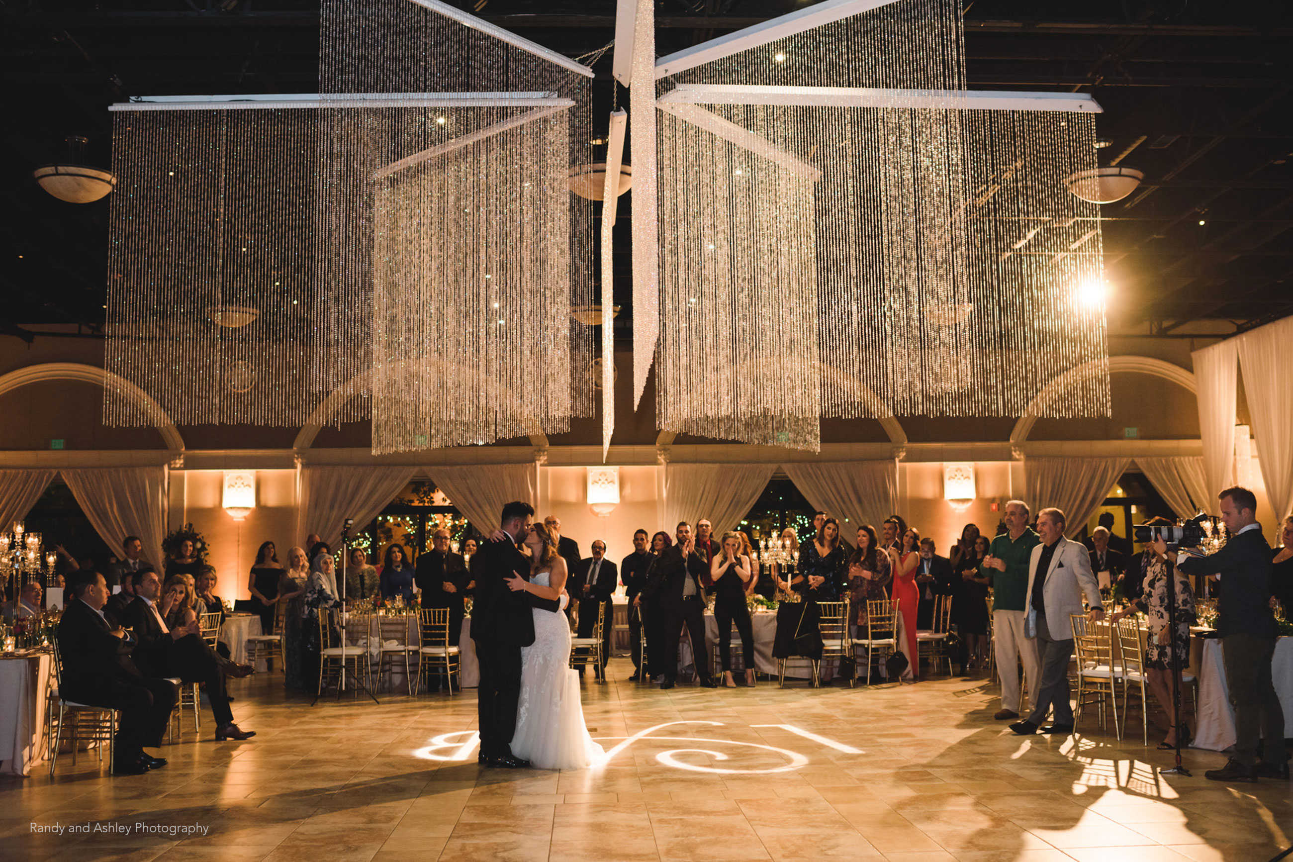 Beautiful first dance with overhead star chandelier during wedding reception at Casa Real at Ruby Hill Winery (www.casarealevents.com).  Photo by: Randy and Ashley Photography; Lighting: Fantasy Sound Event Services