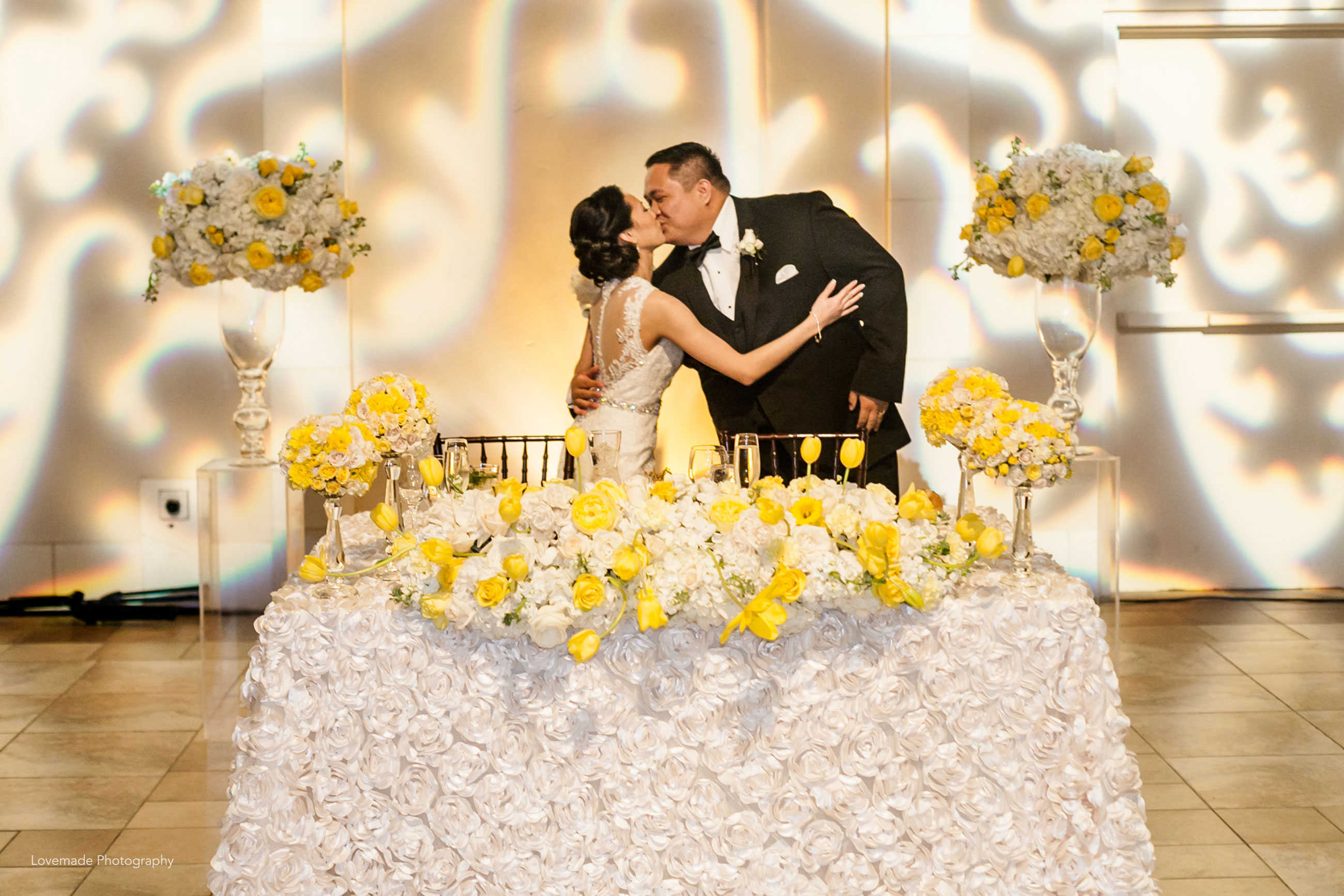 Luxurious yellow and white head table at Casa Real at Ruby Hill Winery (www.casarealevents.com).  Photo by: Lovemade Photography; Florals: Nicole Ha Design; Linen: Napa Valley Linens; Lighting: Enhanced Lighting