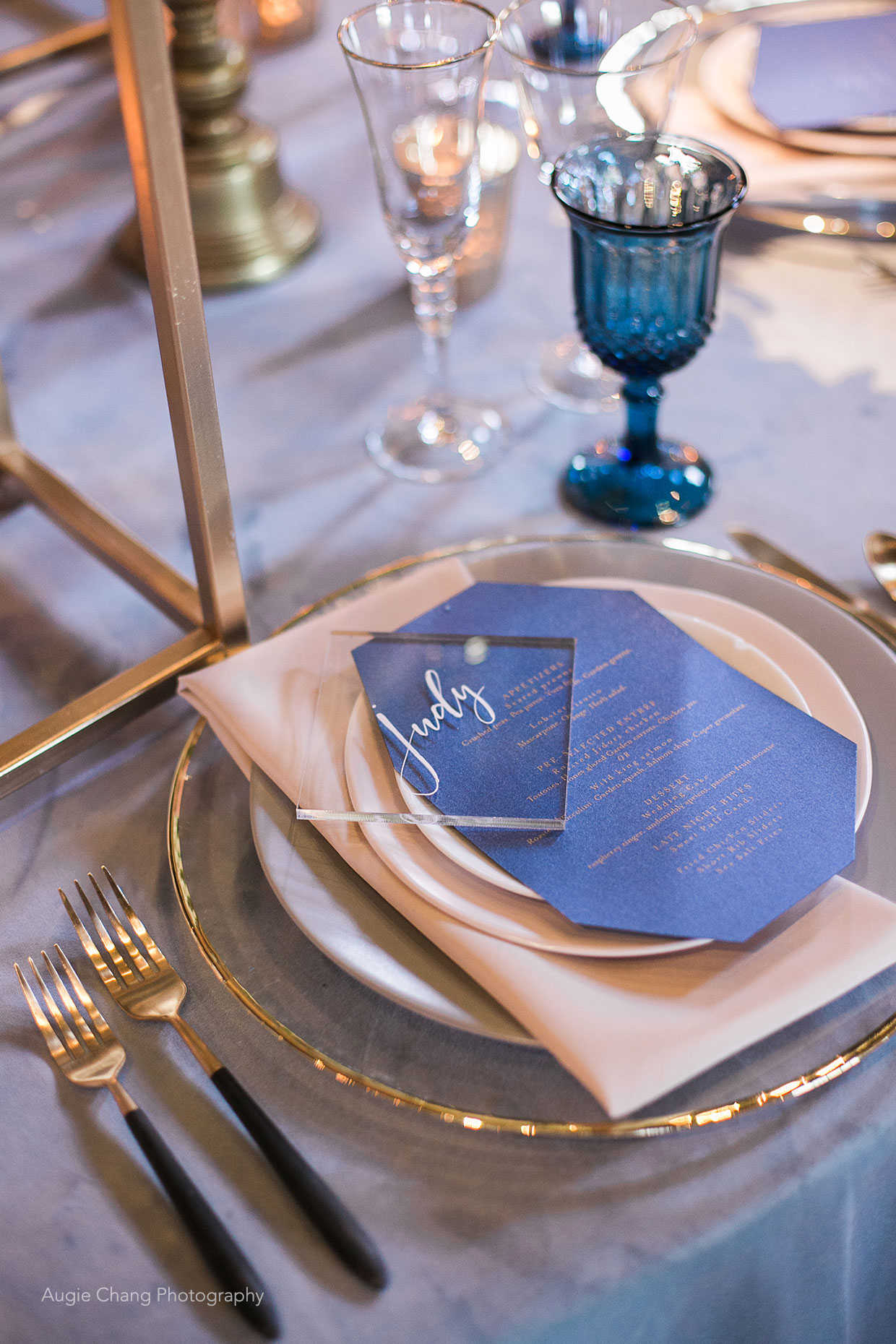 Gold, peach, grey and blue wedding reception table place setting at Casa Real at Ruby Hill Winery (www.casarealevents.com).  Photo by: Augie Chang Photography; Linens and Tabletop Rentals: Pleasanton Rentals; Menu and Place Card: JK Design